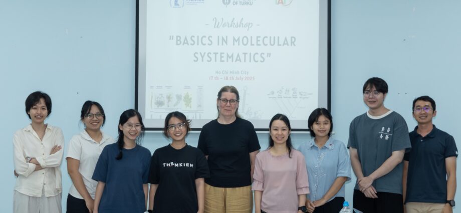 A group of people standing in front of a white board AI-generated content may be incorrect.